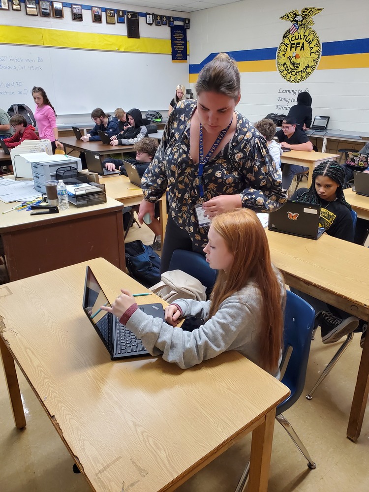 Ms. Stegbauer assisting a student in class