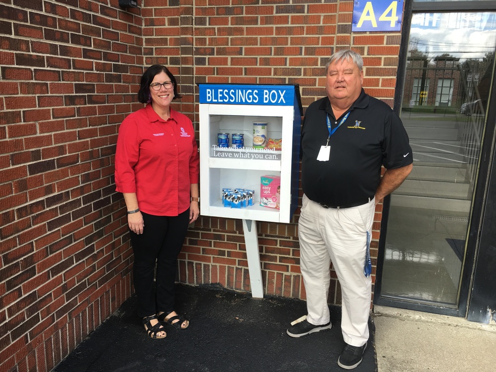 Becky Fiscus, with Ohio State University Extension, and Clermont Northeastern Preschool Director Wayne Johnson stand next to the blessing box at the preschool in Owensville. (Photo by Dick Maloney.)