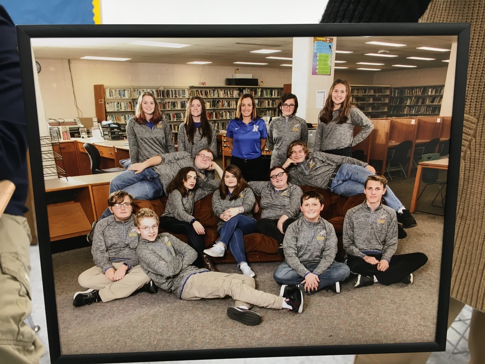 Members of Clermont Northeastern’s academic quiz team pose in a “Friends”-like group photo in the school’s library.
