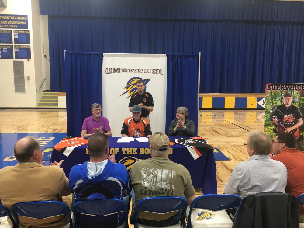 Tommy Averwater, center, and his parents Tom, left, and Sharon, right, with Union College archery coach Cody Kirby in the background, as Tommy signs his archery letter-of-intent. Photo by Dick Maloney.