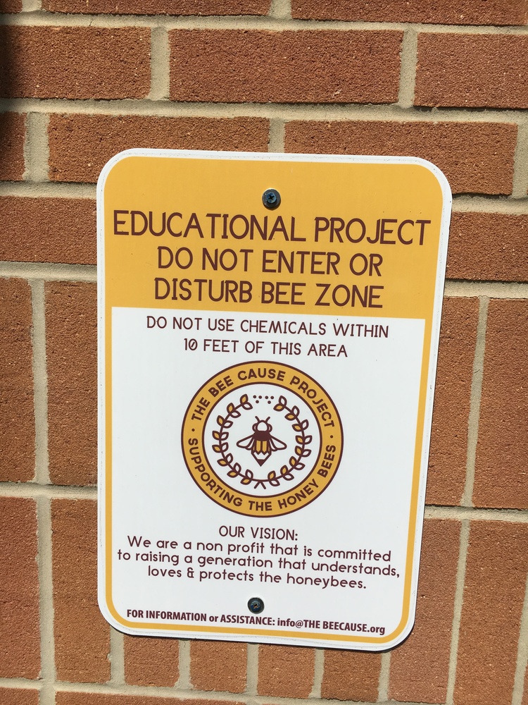 A sign advises visitors of a working beehive at Clermont Northeastern High School.