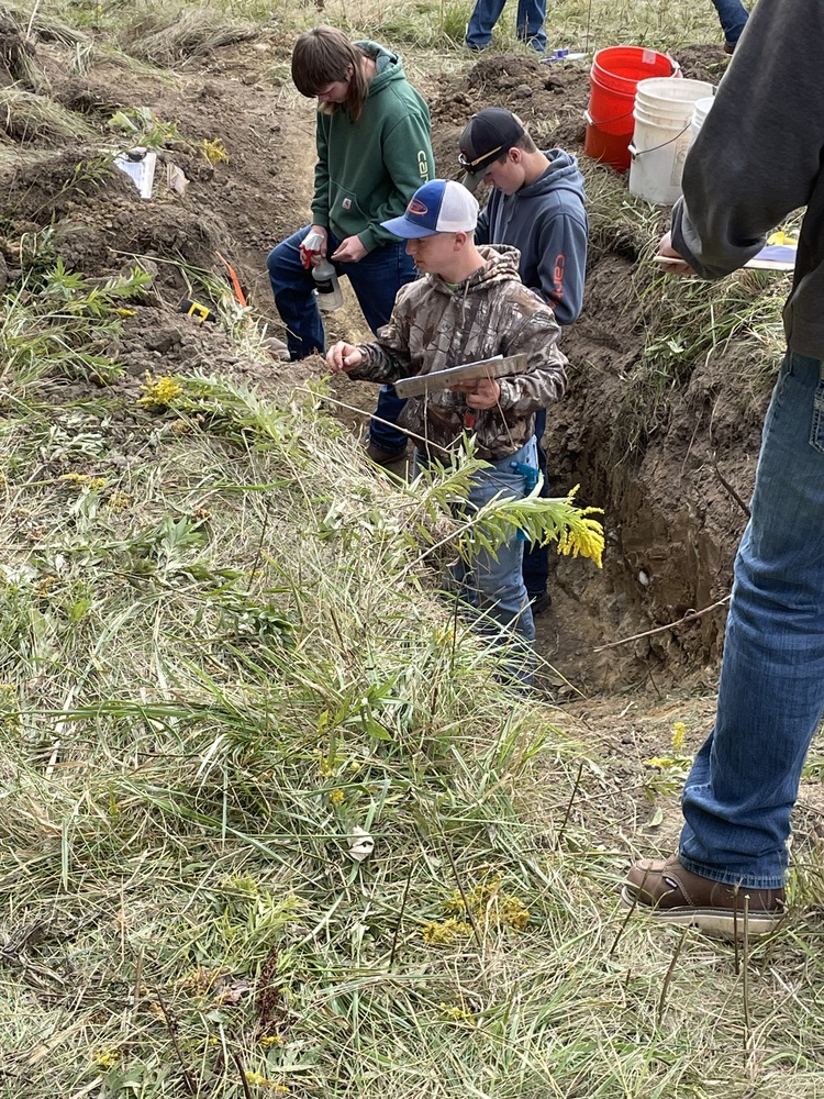 Clermont Northeastern junior Alex Busam takes soil samples from a pit during the District 9 soil judging competition at Miami University. (Photo courtesy Faith Stegbauer.)