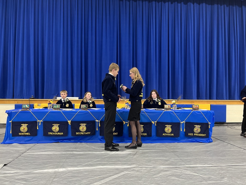Outgoing Clermont Northeastern FFA President Hannah Heller pins a corsage on incoming President Will Mathews during the group’s annual banquet April 28 at the high school. (Photo by Dick Maloney.)