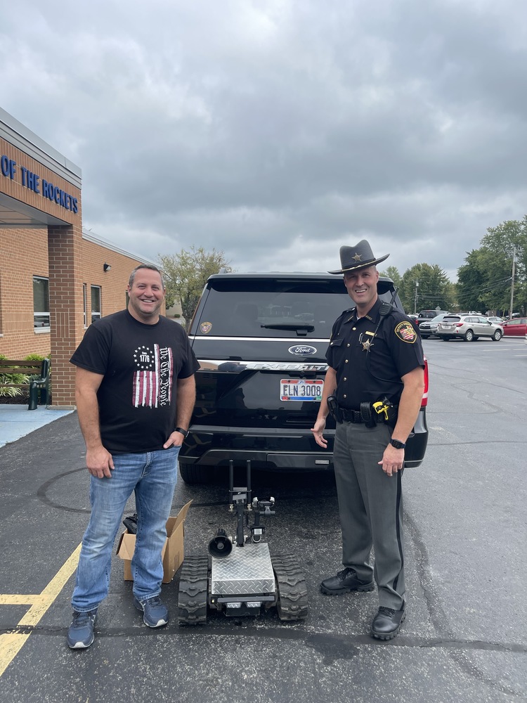 Clermont Northeastern High School teacher Cihan Taktak and School Resource Officer Ryan Patton with the robot track rover the Clermont County Sheriff’s office gave to the school. (Photo courtesy Clermont Northeastern Schools.)