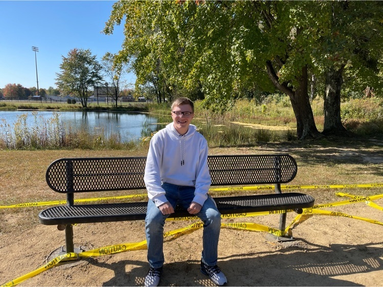 Clermont Northeastern senior Bryce Pillman sits on one of the metal benches he installed on the school campus as part of his Eagle Scout service project. (Photo courtesy CNE Schools.)