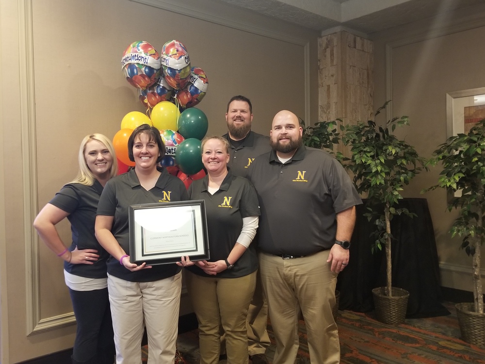 The Clermont Northeastern School District delegation accepts its bronze level award for PBIS implementation at the 2018 Ohio PBIS Showcase in Worthington in November. From left: kindergarten teacher Shannon Backer (CNE Elementary), sixth-grade teacher Tracey Kirk (CNE Middle School), seventh-grade math teacher Cindy Dorsey (CNE Middle School), band director Chris Moore (CNE High School) and Travis Dorsey, CNE Dean of Students