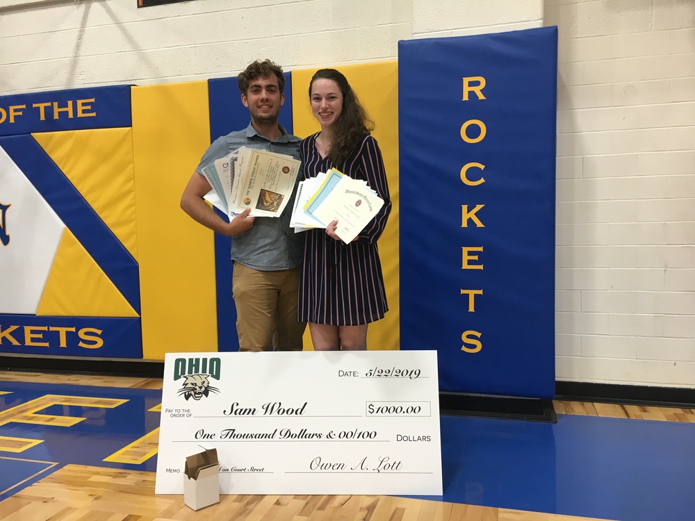 Clermont Northeastern High School seniors Sam Wood and Jillian Kirby show the combined 13 scholarships they received at the school’s Senior Awards Night May 22. (Photo by Dick Maloney.)
